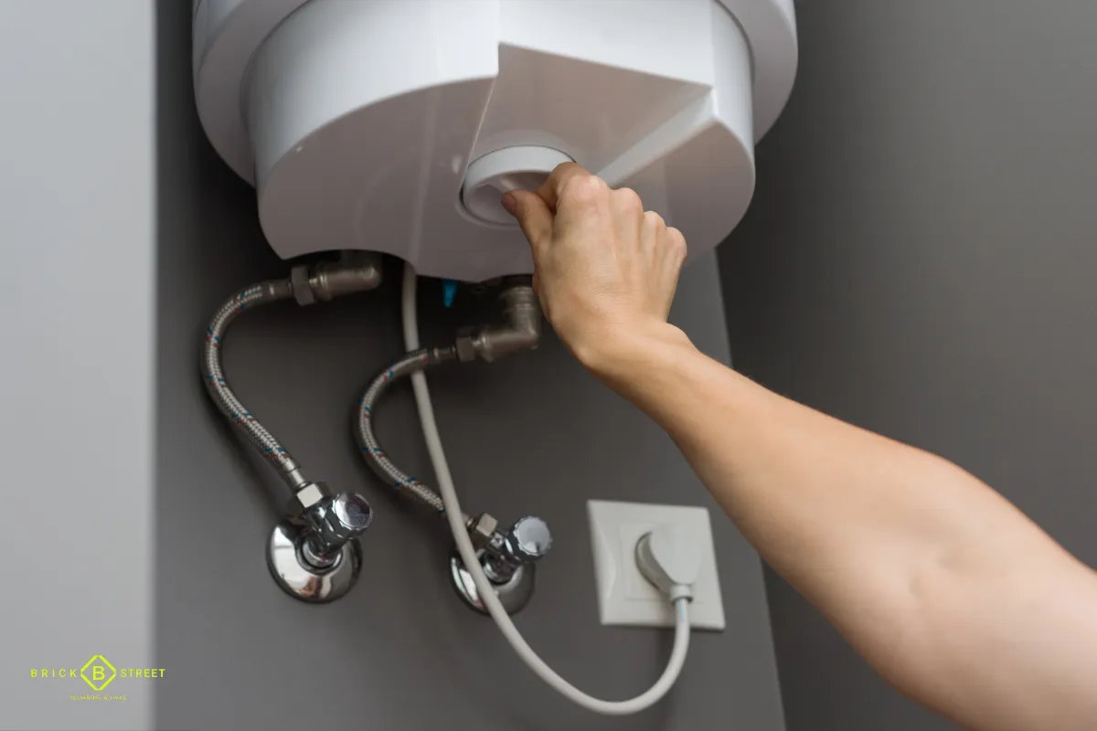 Wall-mounted electric water heater being adjusted
